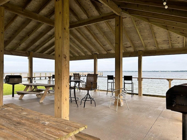 view of patio / terrace featuring a gazebo, a water view, and a grill