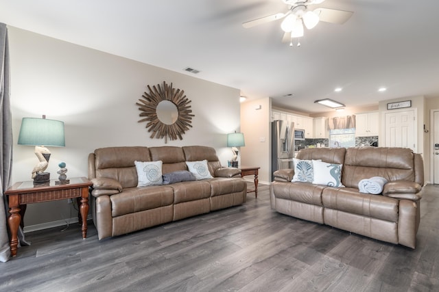 living room with ceiling fan and dark wood-type flooring