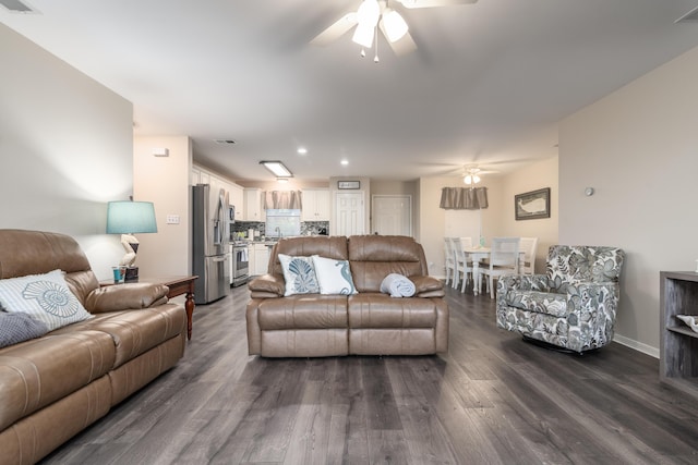 living room featuring hardwood / wood-style floors and ceiling fan