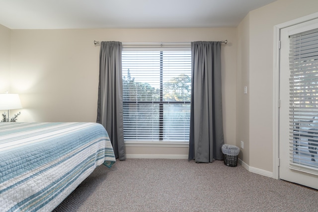 bedroom featuring light carpet and access to outside