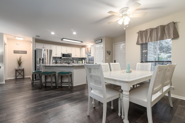 dining area with ceiling fan and dark hardwood / wood-style flooring