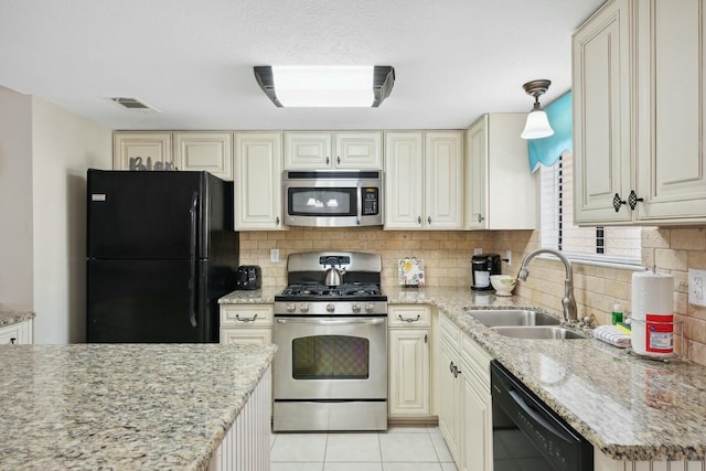 kitchen with sink, pendant lighting, decorative backsplash, light tile patterned flooring, and black appliances