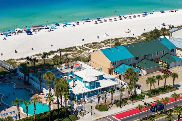 drone / aerial view featuring a water view and a beach view