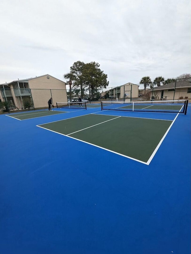 view of sport court with basketball hoop