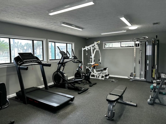 workout area featuring a textured ceiling