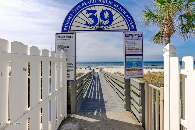 surrounding community featuring a beach view and a water view