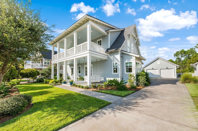 view of front of house with a garage, a front yard, an outbuilding, and covered porch