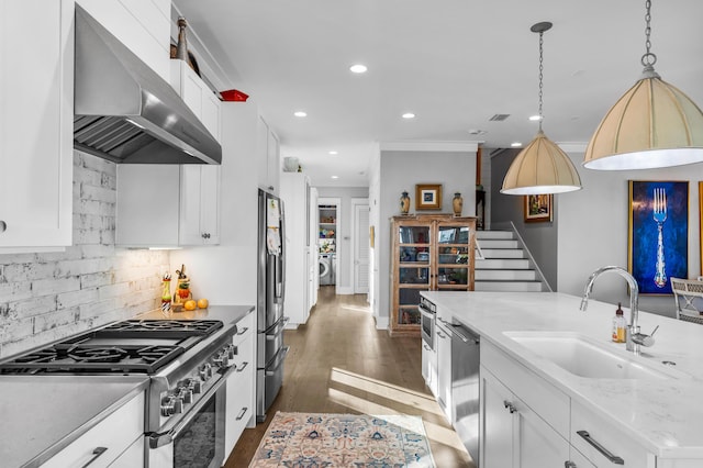 kitchen with stainless steel appliances, white cabinetry, sink, and wall chimney exhaust hood