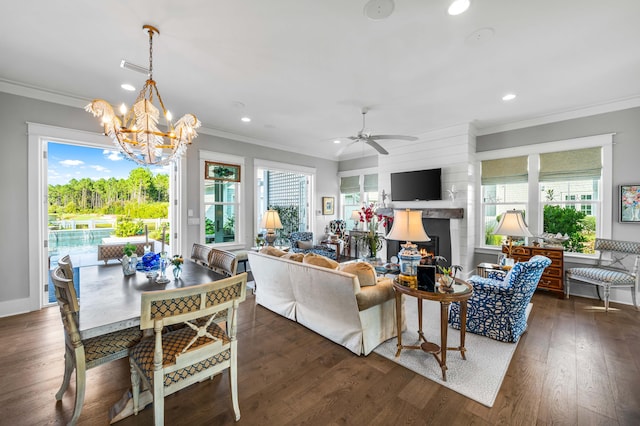 living room with crown molding, plenty of natural light, and dark hardwood / wood-style flooring