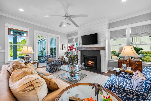 living room featuring hardwood / wood-style floors, ornamental molding, french doors, and ceiling fan