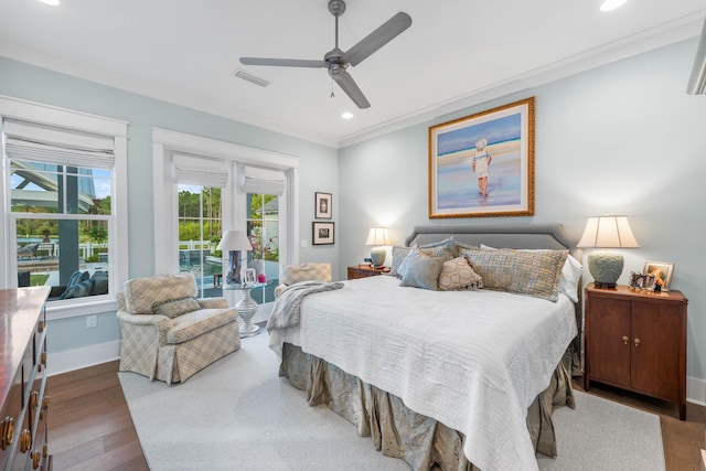 bedroom featuring crown molding, ceiling fan, and dark hardwood / wood-style flooring