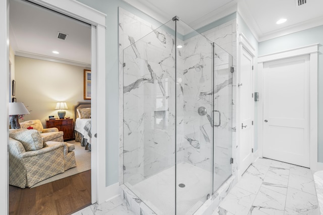 bathroom featuring ornamental molding and a shower with shower door