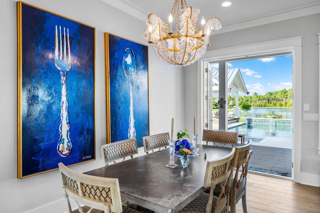 dining room featuring an inviting chandelier, wood-type flooring, and crown molding