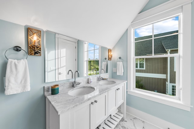 bathroom with lofted ceiling and vanity