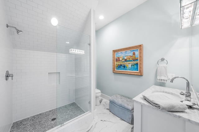 bathroom with vanity, toilet, and a shower with door