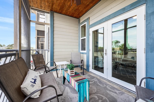 sunroom / solarium featuring a wealth of natural light, french doors, and wooden ceiling