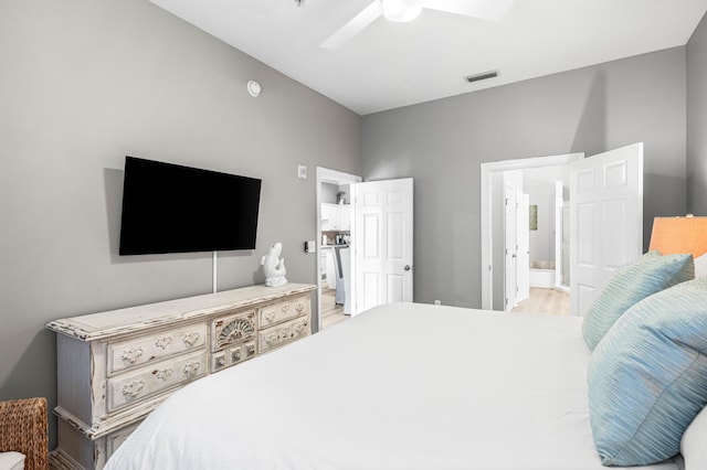 bedroom with ensuite bath, ceiling fan, and wood-type flooring