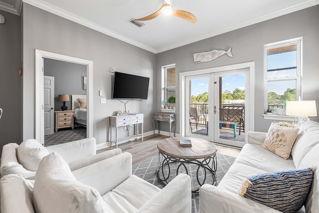 living room featuring ceiling fan, french doors, crown molding, and hardwood / wood-style flooring