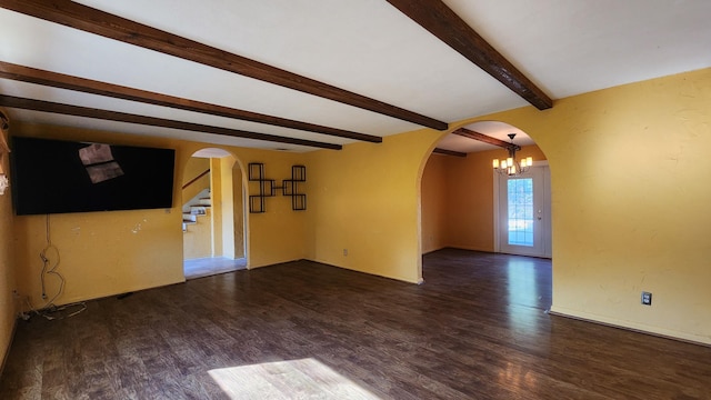 unfurnished living room with dark hardwood / wood-style flooring, beamed ceiling, and an inviting chandelier