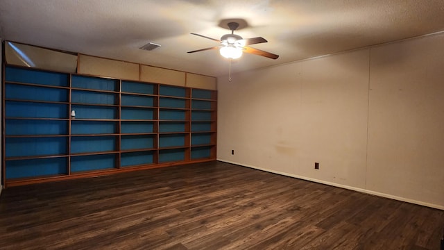 empty room featuring ceiling fan and dark wood-type flooring