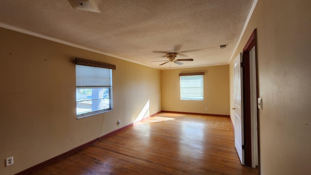 empty room with a textured ceiling, light hardwood / wood-style floors, ceiling fan, and ornamental molding