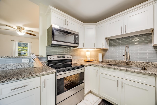 kitchen featuring sink, white cabinetry, stainless steel appliances, and tasteful backsplash