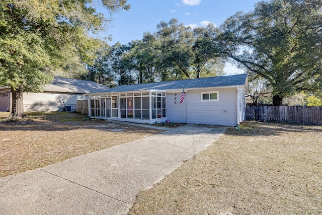 single story home featuring a sunroom