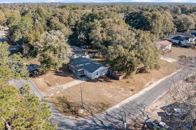 birds eye view of property with a forest view