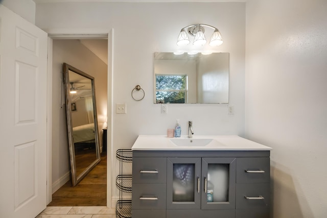 ensuite bathroom featuring baseboards, ensuite bathroom, and vanity