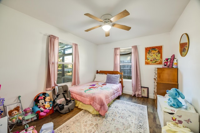 bedroom with dark wood finished floors and a ceiling fan