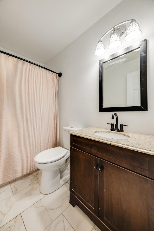 full bathroom featuring toilet, marble finish floor, and vanity