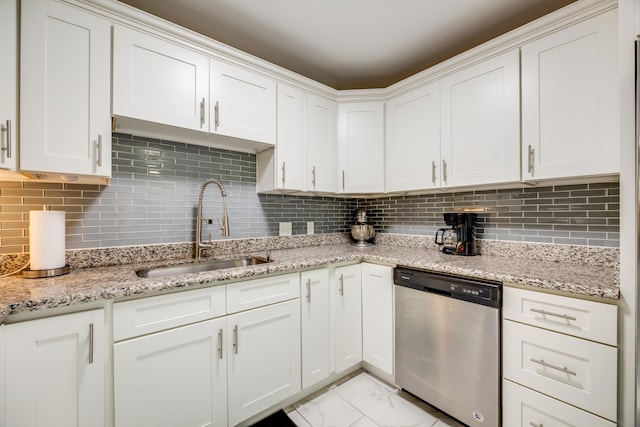 kitchen with a sink, white cabinetry, marble finish floor, dishwasher, and tasteful backsplash