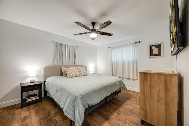 bedroom featuring ceiling fan, baseboards, and dark wood-type flooring