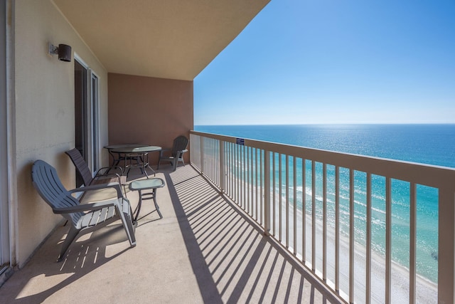 balcony with a beach view and a water view