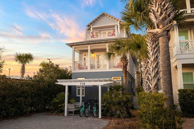 exterior space with a balcony and a pergola