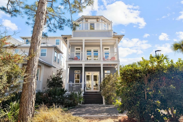 view of front of home featuring french doors and a balcony