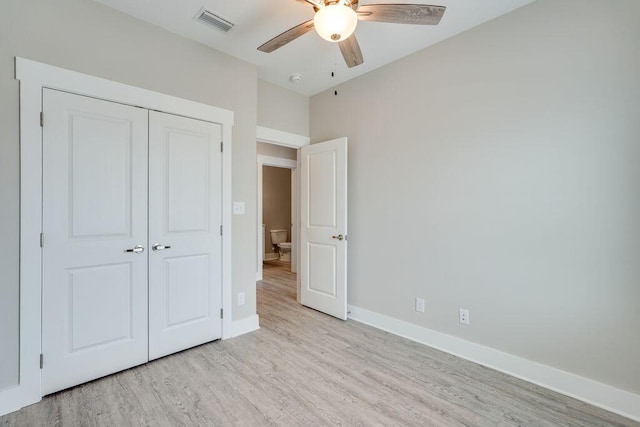 unfurnished bedroom with a closet, light hardwood / wood-style flooring, and ceiling fan