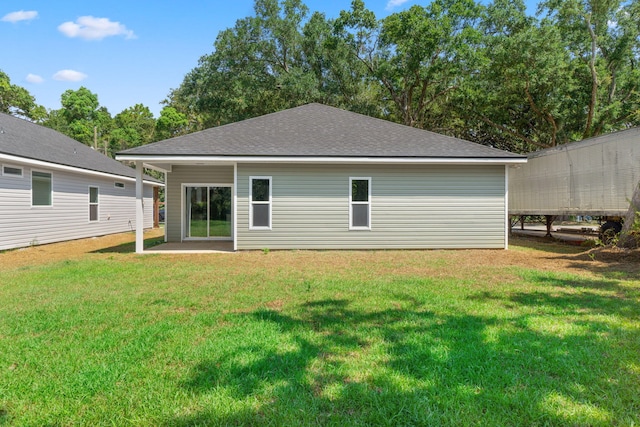 rear view of house featuring a lawn and a patio area