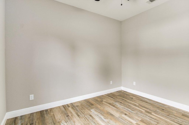 spare room with light wood-type flooring and ceiling fan