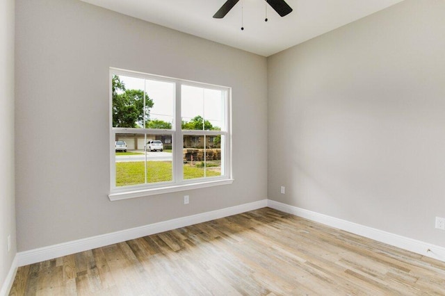 spare room featuring light hardwood / wood-style floors and ceiling fan