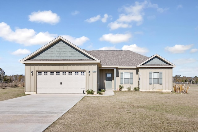 view of front of property with a garage and a front lawn