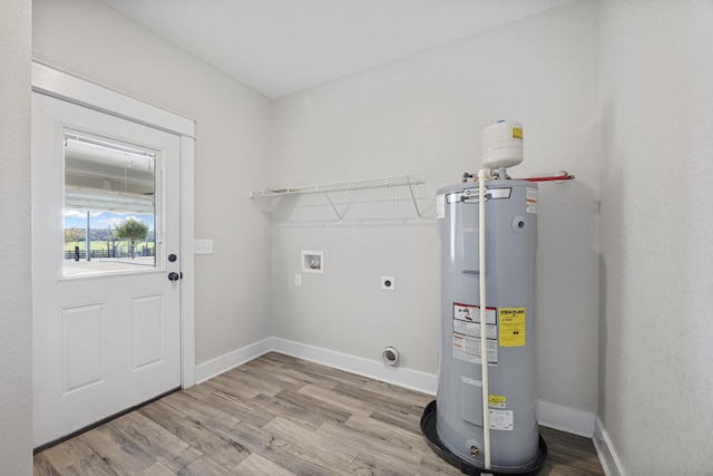 washroom with light wood-type flooring, washer hookup, electric water heater, and electric dryer hookup