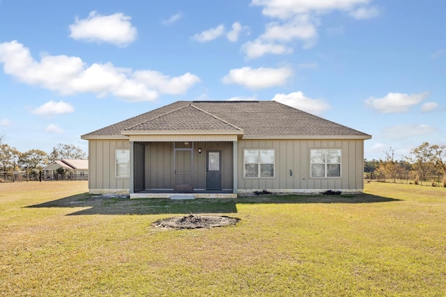 rear view of property featuring a yard