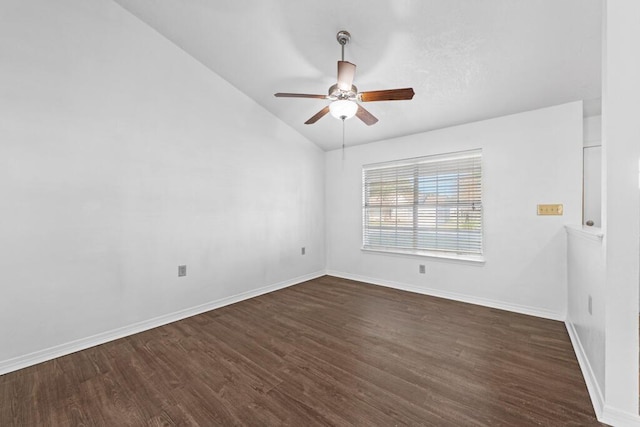 spare room with dark hardwood / wood-style floors, ceiling fan, and vaulted ceiling