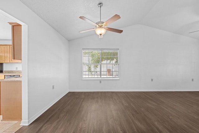 unfurnished living room with ceiling fan, dark hardwood / wood-style flooring, and vaulted ceiling