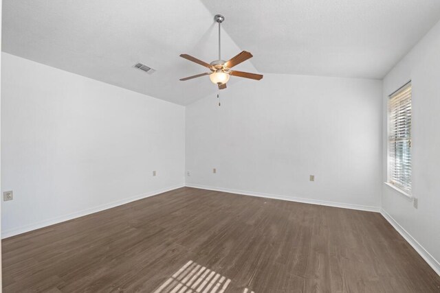 spare room with lofted ceiling, ceiling fan, and dark hardwood / wood-style floors