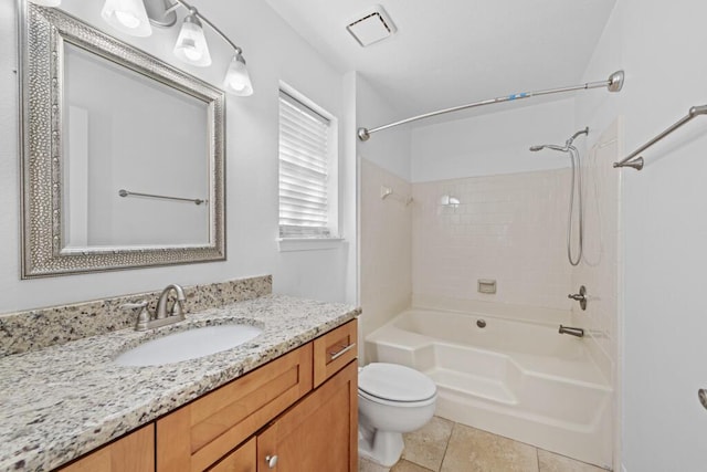 full bathroom featuring toilet, vanity, tile patterned floors, and tiled shower / bath