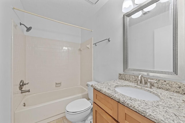 full bathroom with tile patterned floors, vanity, tiled shower / bath combo, and toilet