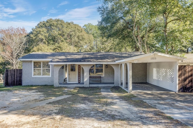 ranch-style house with a porch and a carport