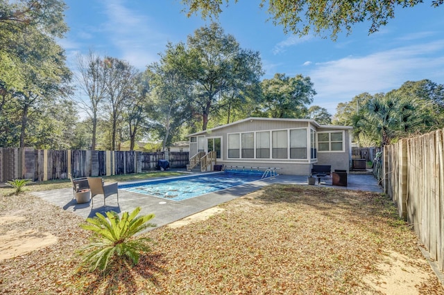 view of swimming pool with a yard and a patio